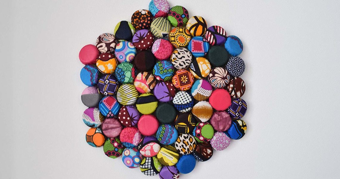 Upcycle bottle caps with kitenge fabric and create unique pieces for your dinning table or wall.